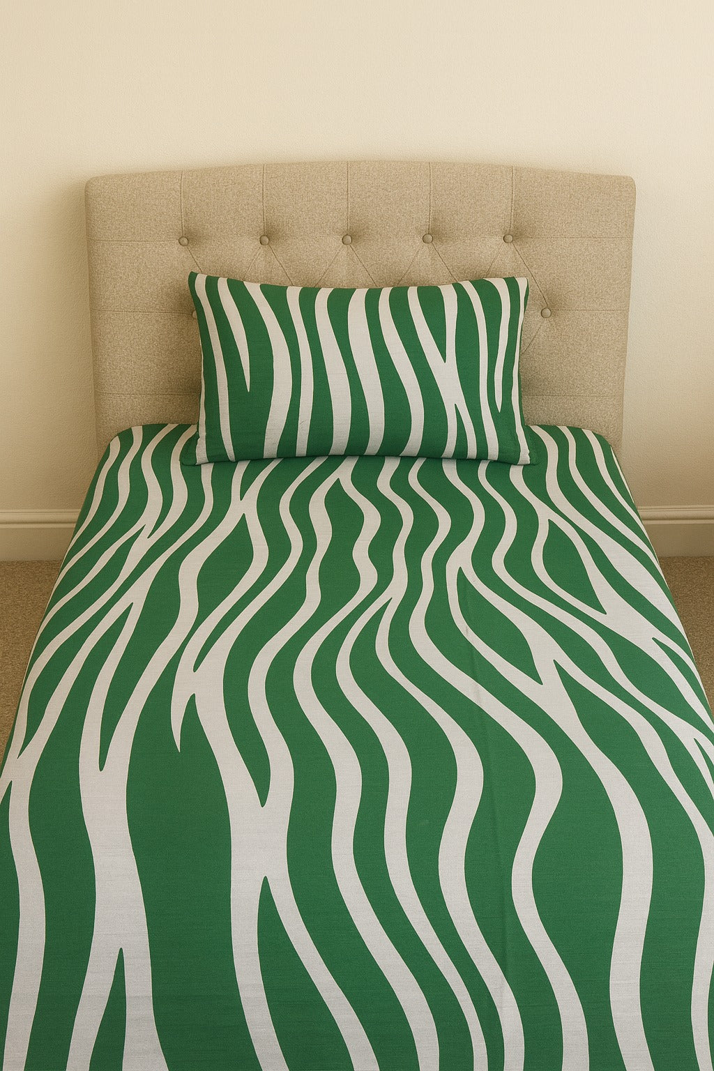 Green and white wavy patterned bedsheet set on a bed with a beige headboard.
