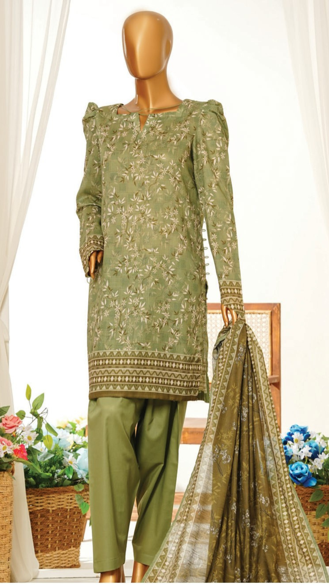 Green printed MTJ traditional outfit with dupatta on a mannequin against a white curtain background.