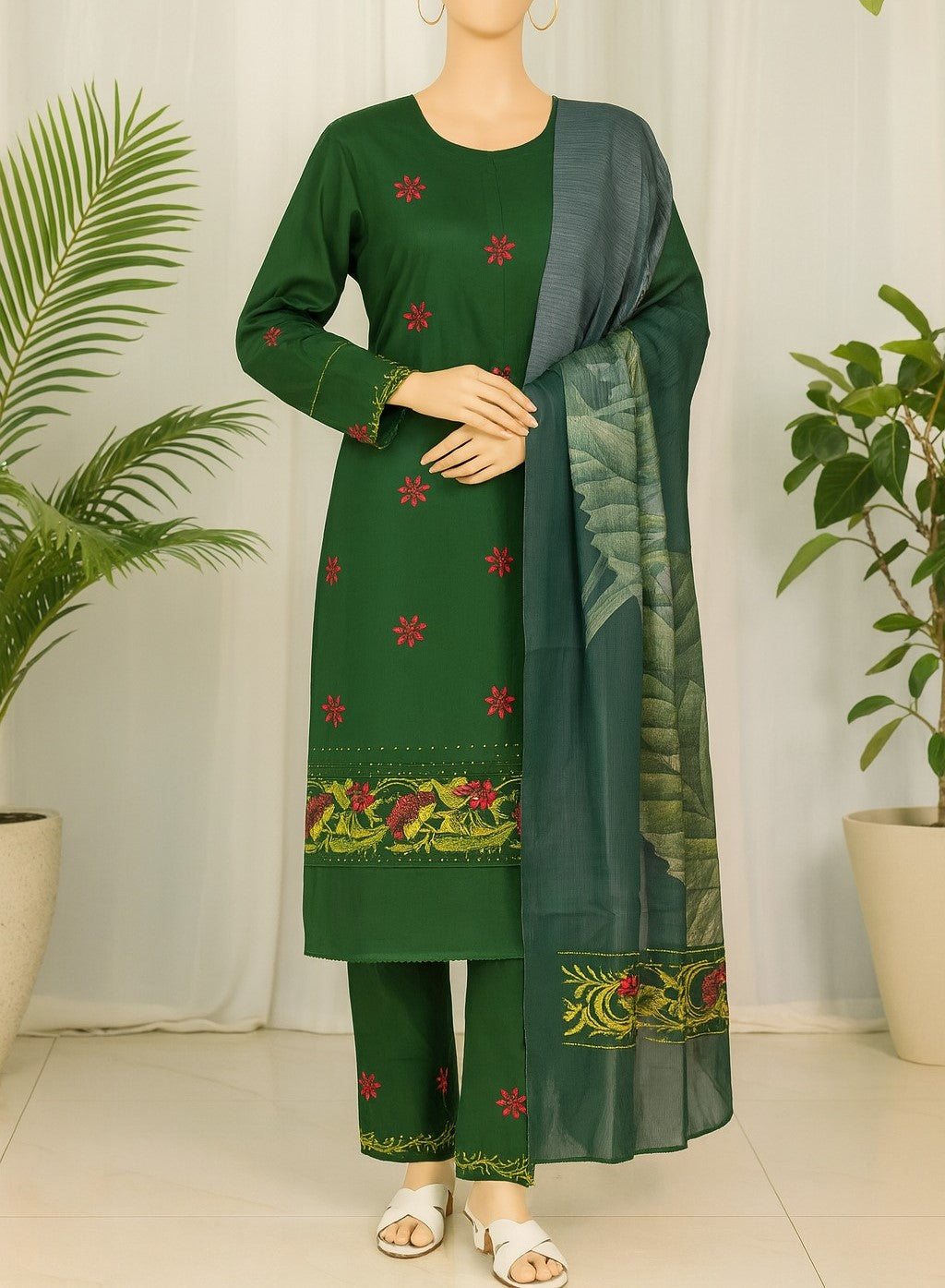 Green traditional outfit with floral patterns on a mannequin against a white curtain background.