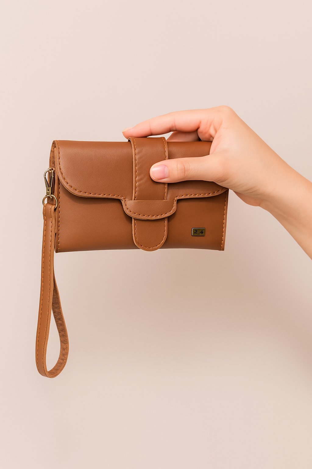 Hand holding a brown leather wallet against a beige background