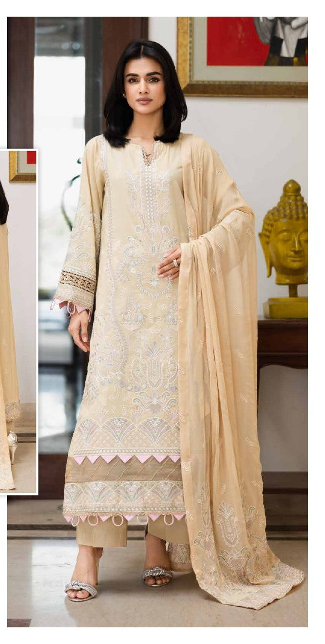 Woman wearing a cream embroidered outfit with a matching dupatta in an indoor setting.