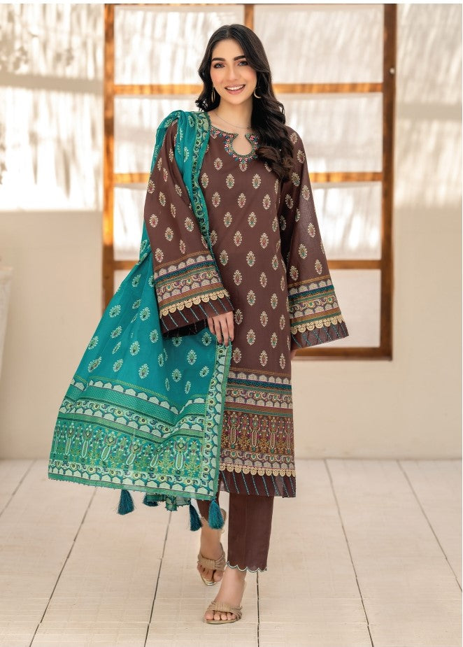 Woman wearing a brown and green patterned outfit with a matching dupatta indoors.