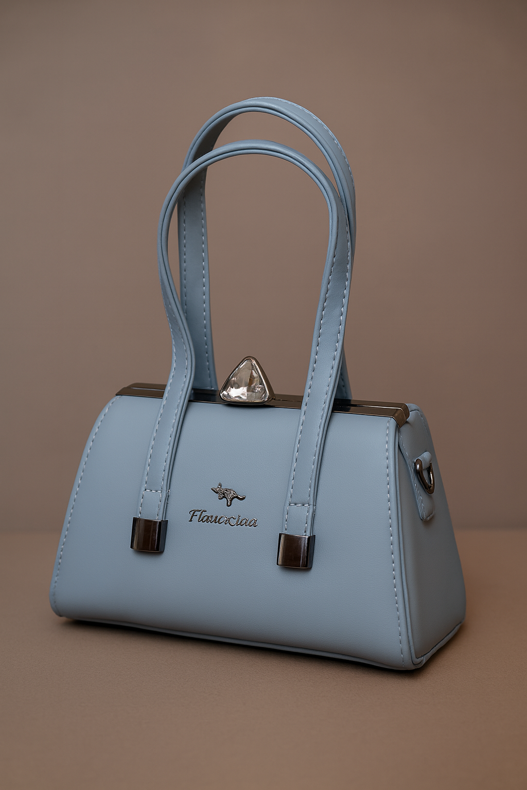Light blue handbag with brown accents on a brown background