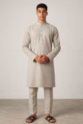 Man wearing a beige kurta with pants against a plain background