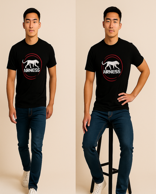 Man wearing a black t-shirt with a logo and text, standing and sitting on a stool against a beige background.