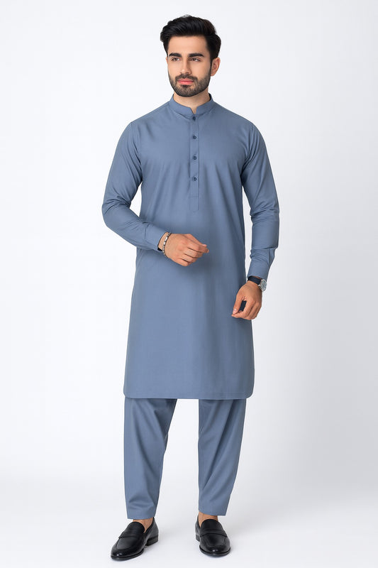 Man wearing a blue kurta with pants on a white background