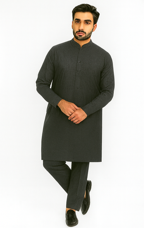 Man wearing a dark gray kurta with pants on a white background