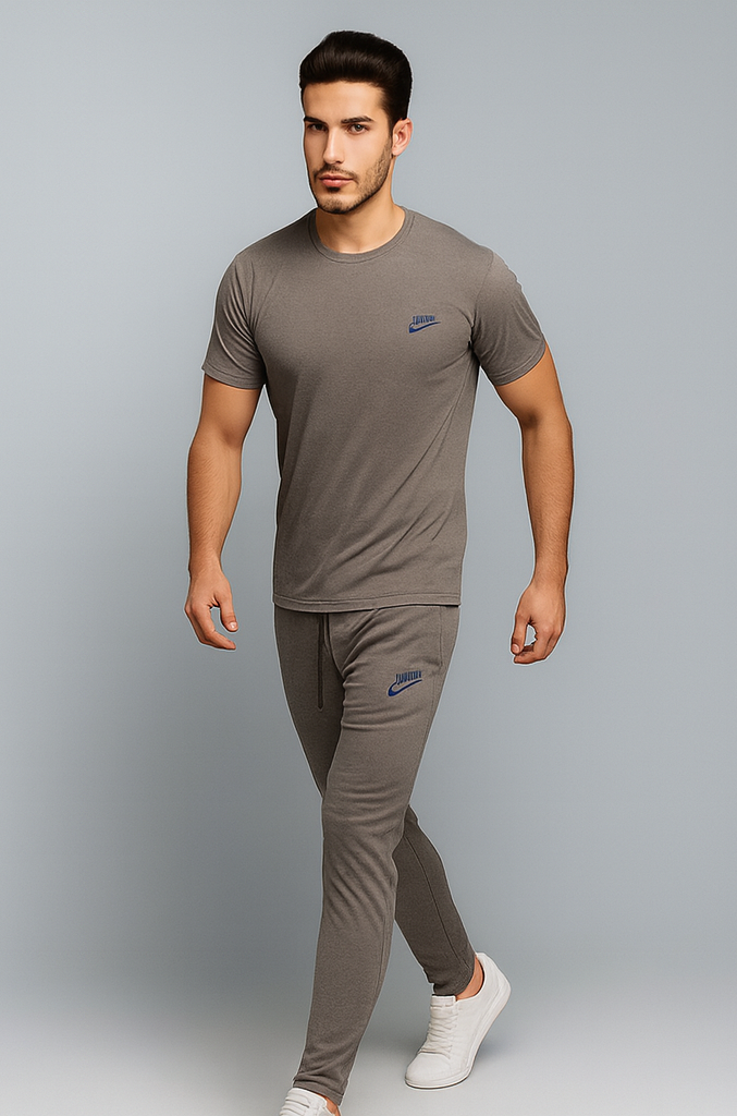 Man wearing a gray Nike t-shirt and trouser on a gray background