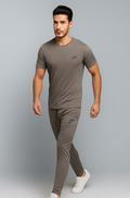 Man wearing a gray Nike t-shirt and trouser on a gray background