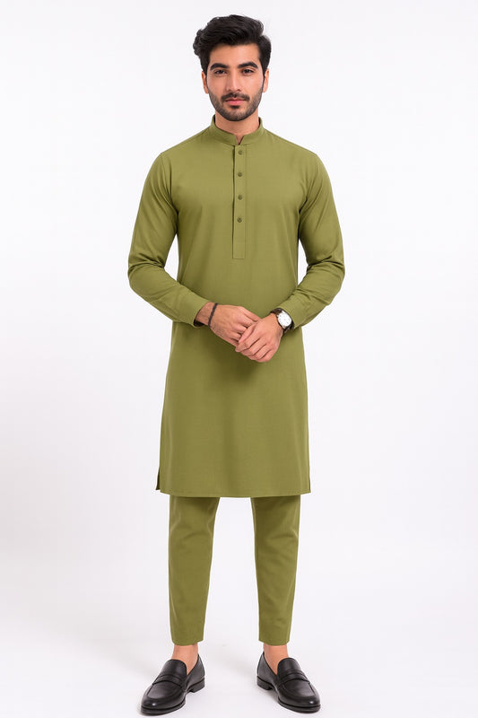 Man wearing a green kurta with pants on a white background