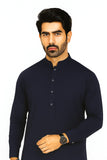 Man wearing a navy blue kurta with a white background