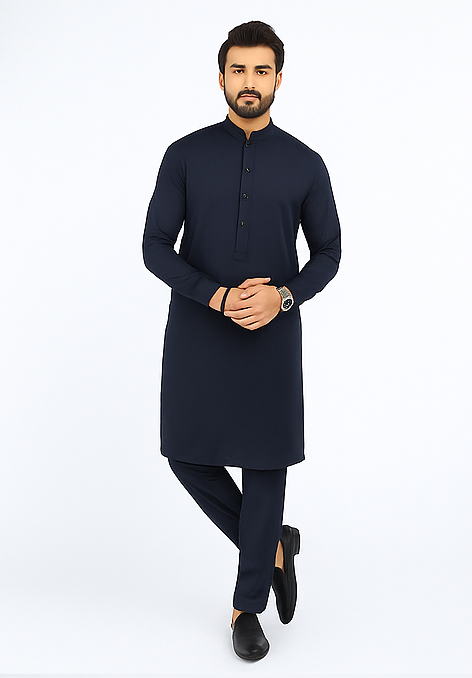 Man wearing a navy kurta with black shoes on a white background
