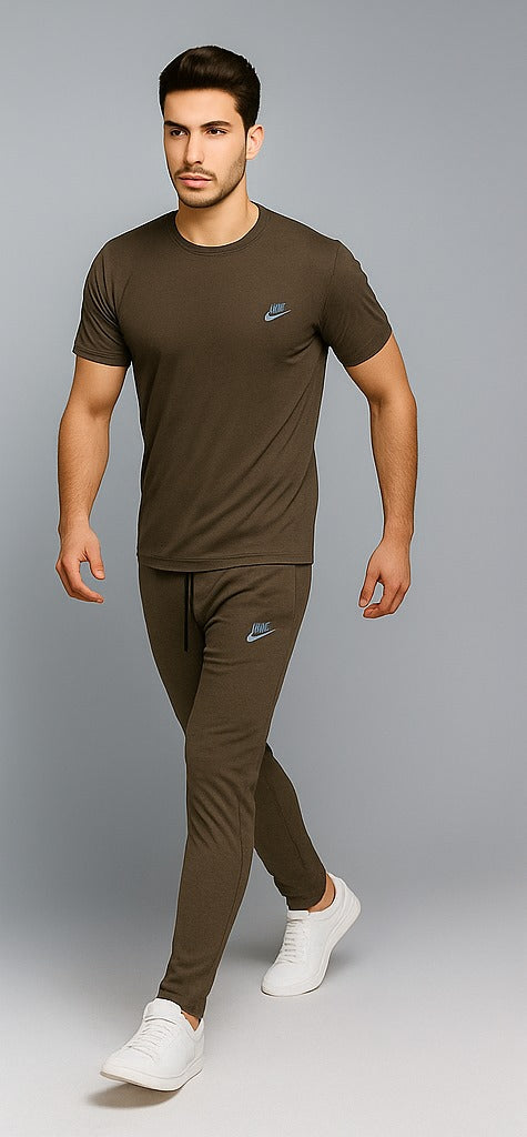 Man wearing a olive Nike outfit on a gray background