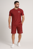 Man wearing a red Under Armour t-shirt and shorts on a white background