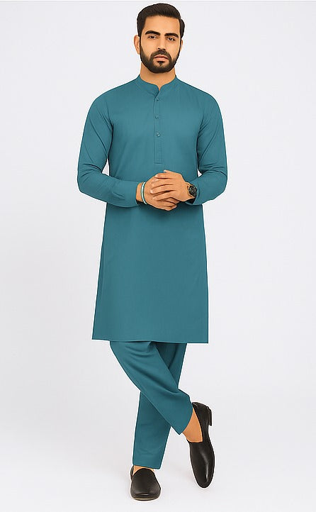 Man wearing a teal kurta with pants on a white background