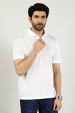 Man wearing a white polo shirt against a plain background