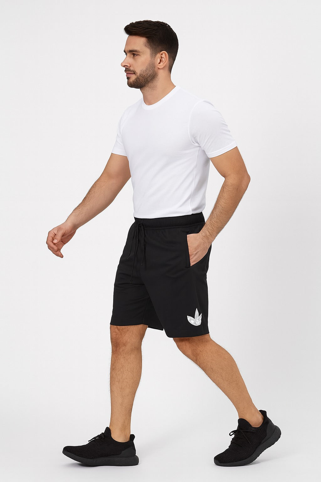 Man wearing black shorts with a white logo on a white background