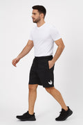 Man wearing black shorts with a white logo on a white background