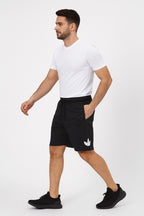 Man wearing black shorts with a white logo on a white background