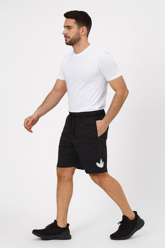 Man wearing black shorts with a white logo on a white background