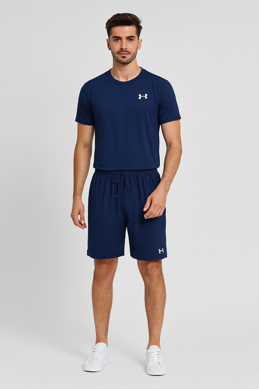 Man wearing navy Under Armour t-shirt and shorts on a light gray background