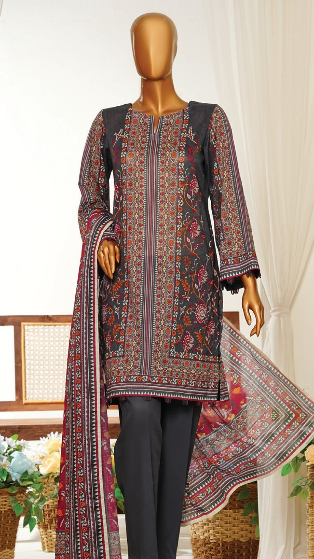 Mannequin MTJ wearing a patterned dress with a floral design in a decorative setting.