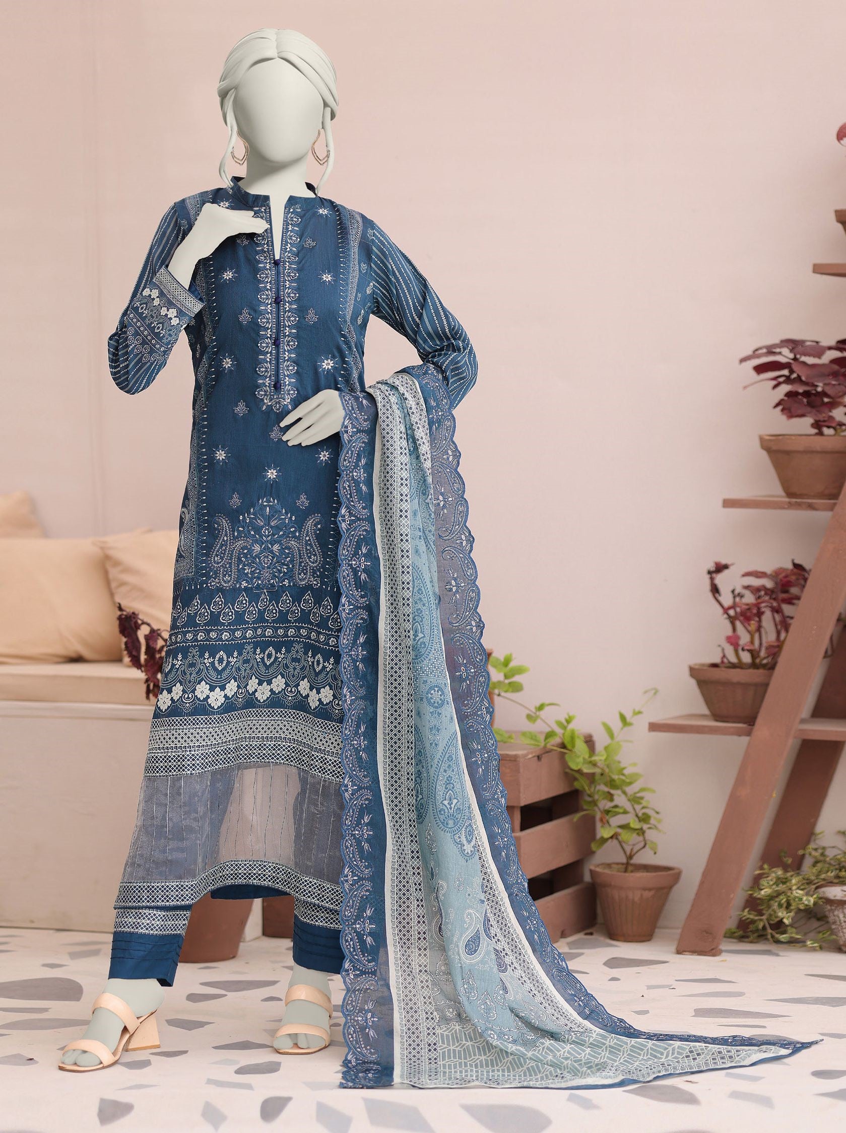 Mannequin wearing a blue embroidered outfit with a matching dupatta in a home setting.