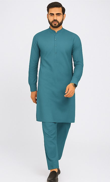 Man wearing a teal kurta with trouser on a white background
