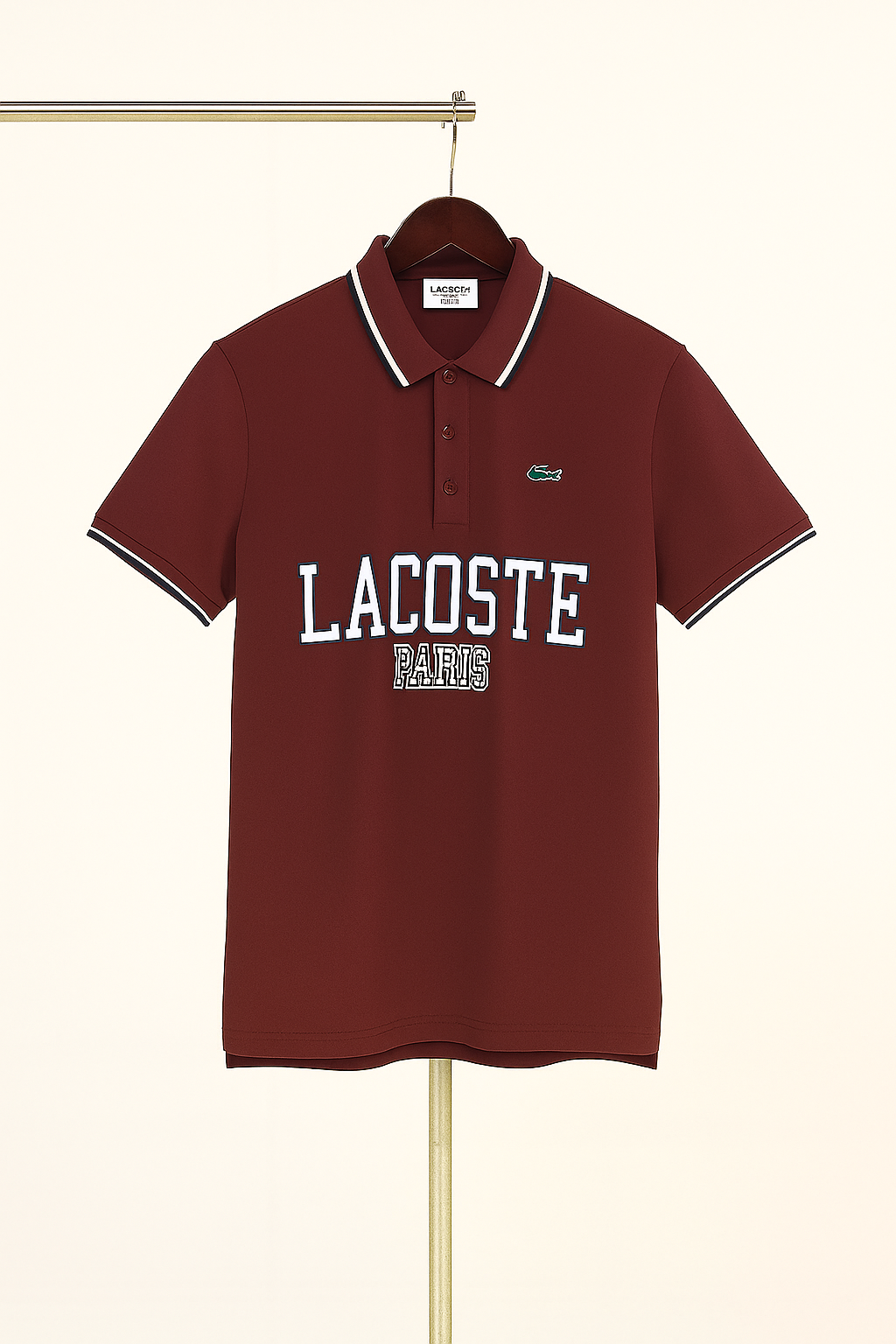 Maroon Lacoste polo shirt on a hanger against a white background