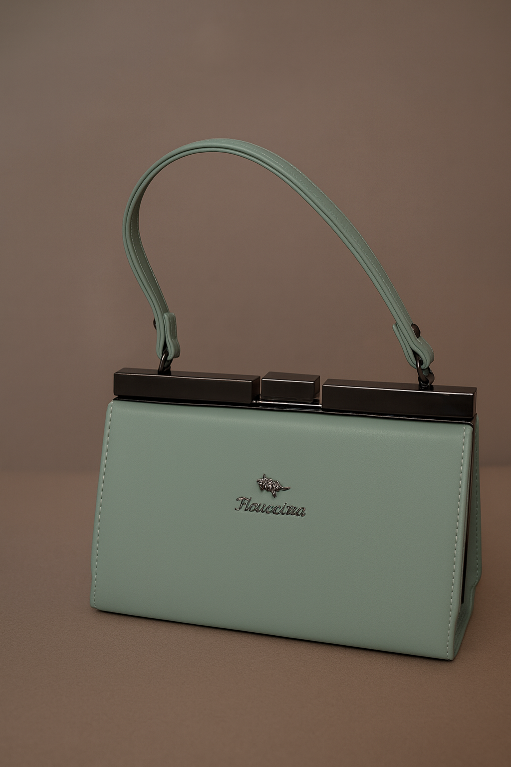 Mint green handbag with a handle on a brown background