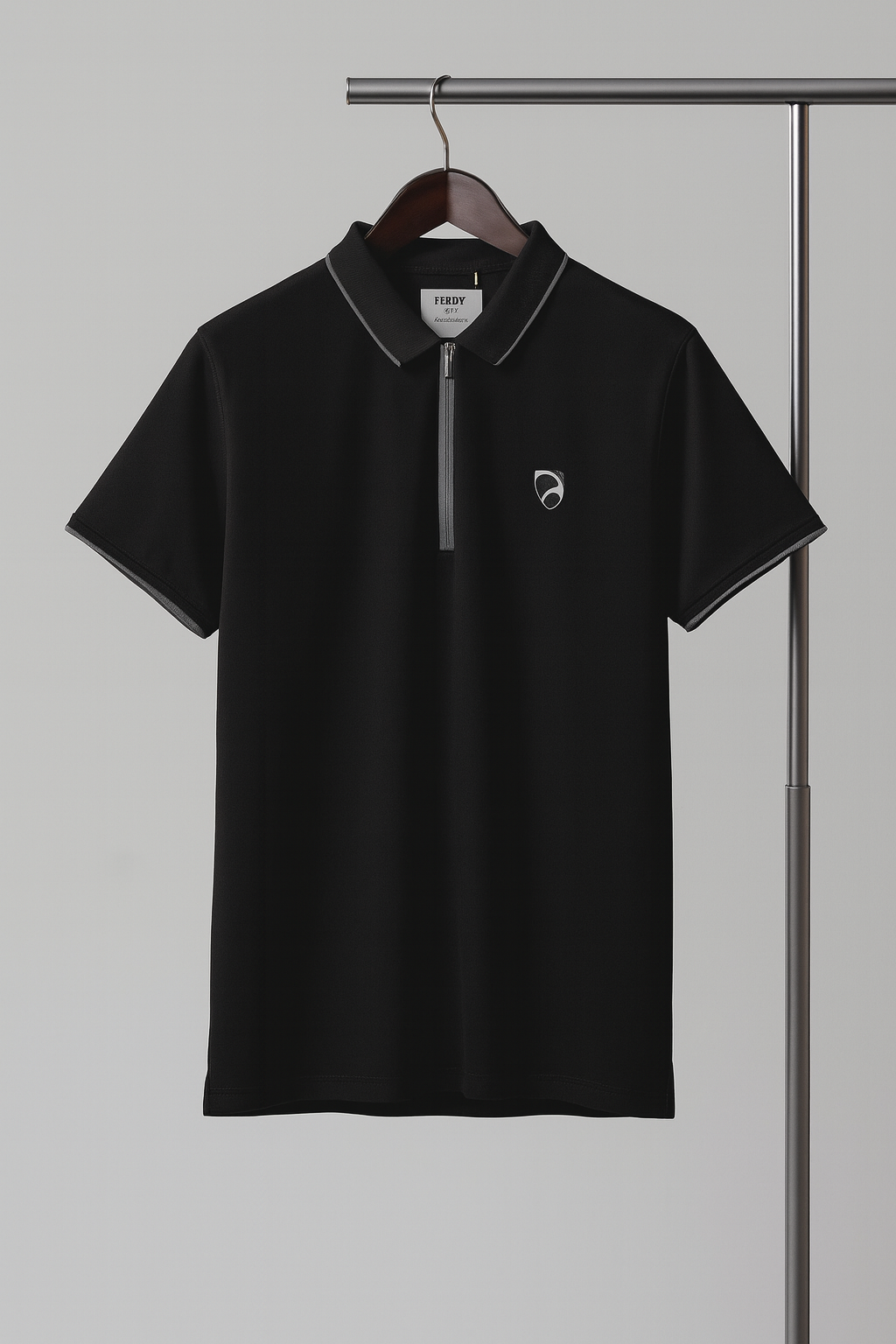 Black polo shirt with a small logo on a hanger against a gray background