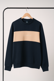 Navy and beige sweatshirt on a hanger against a white background