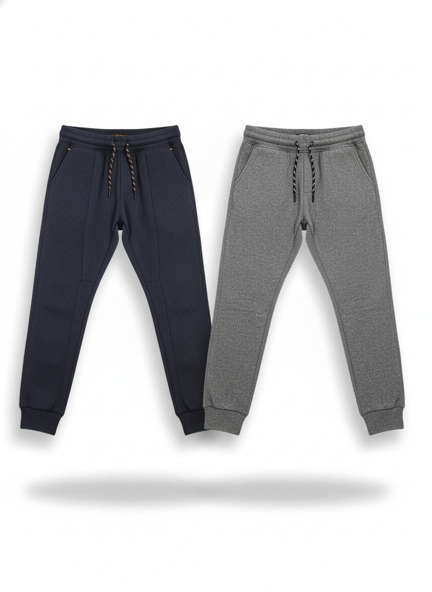 Navy and gray jogger pants on a white background