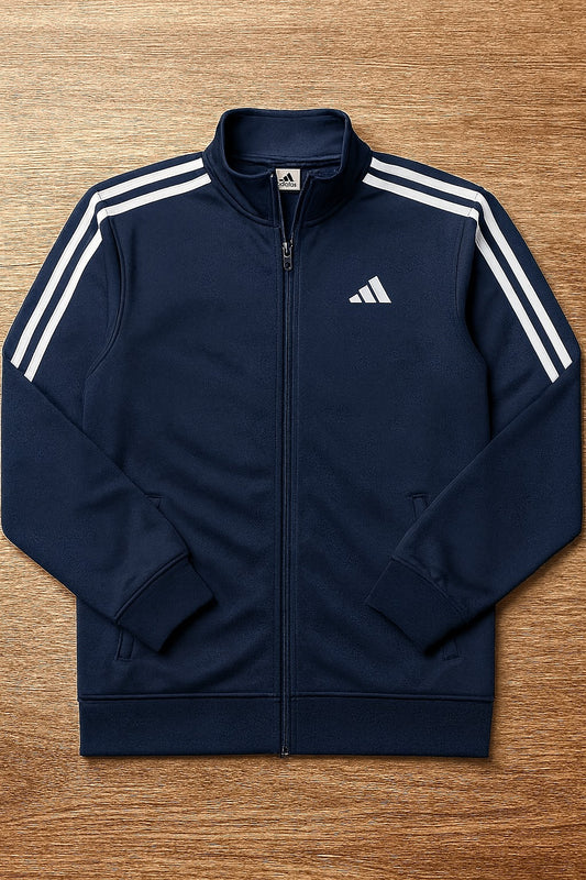 Navy blue Adidas jacket with white stripes on a wooden surface