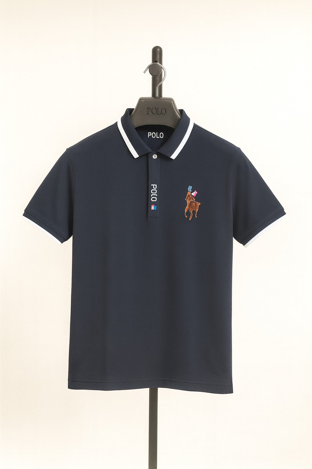 Navy blue Polo shirt with embroidered logo on a hanger against a white background