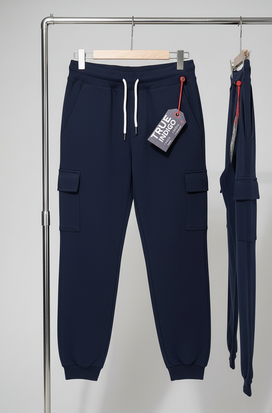 Navy blue cargo jogger pants with a tag on a gray background