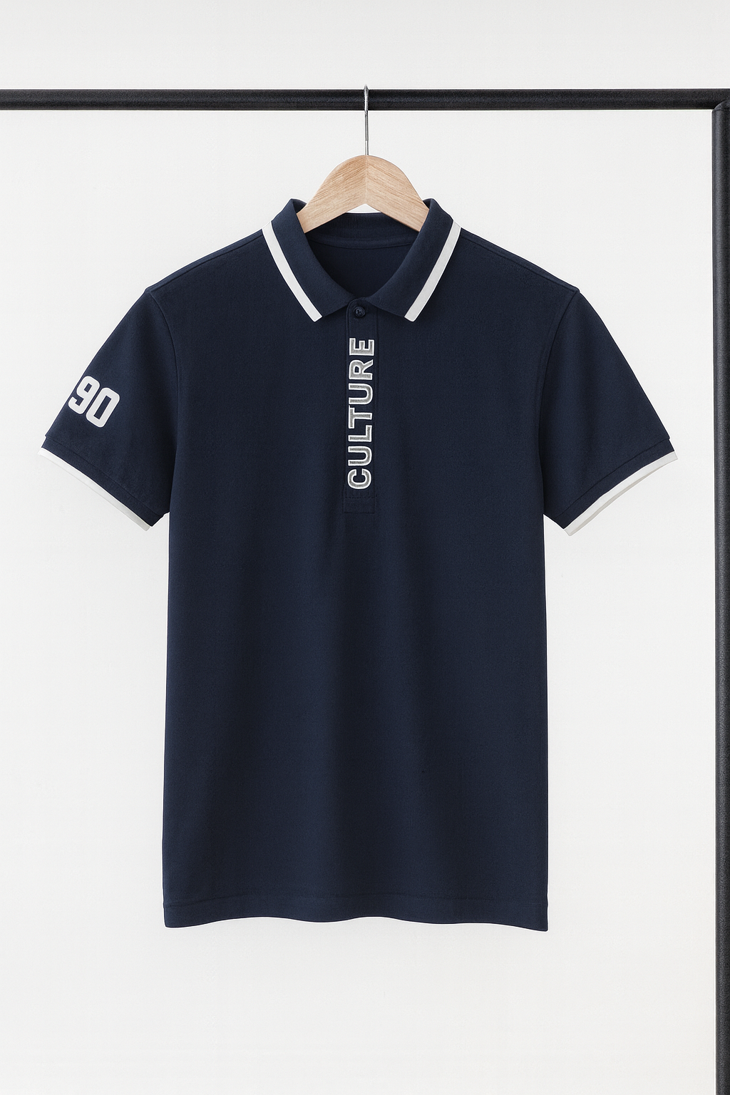 Navy blue polo shirt with white text on a hanger against a white background