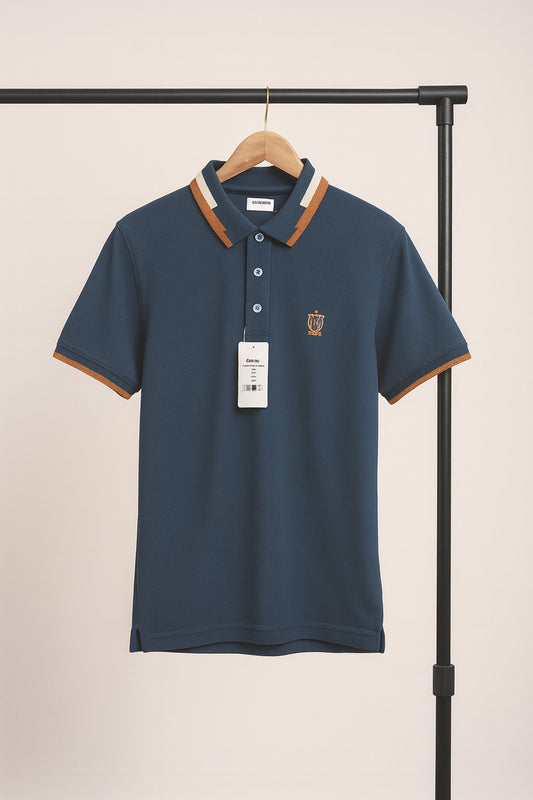 Navy blue polo shirt with brown accents on a hanger against a beige background