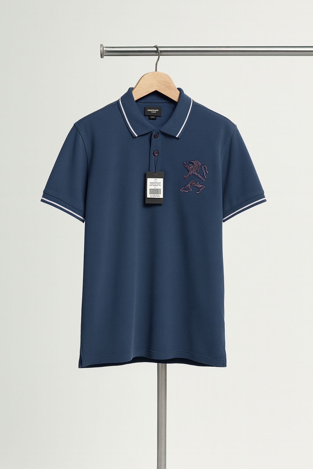 Navy blue polo shirt with a brand logo on a hanger against a light gray background