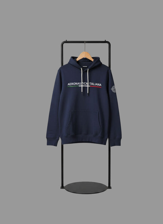 Navy hoodie with brand logo on a black stand against a gray background