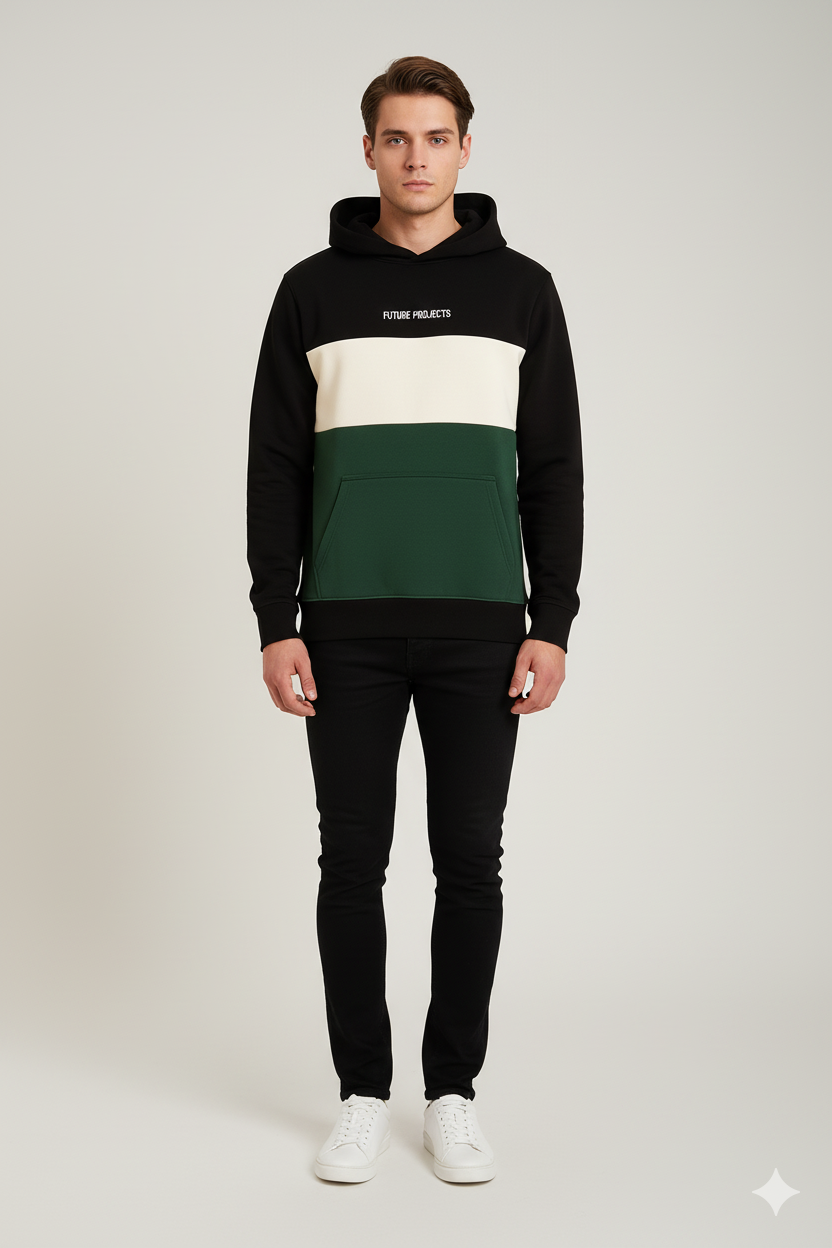 Person wearing a black, white, and green color-blocked hoodie on a light gray background