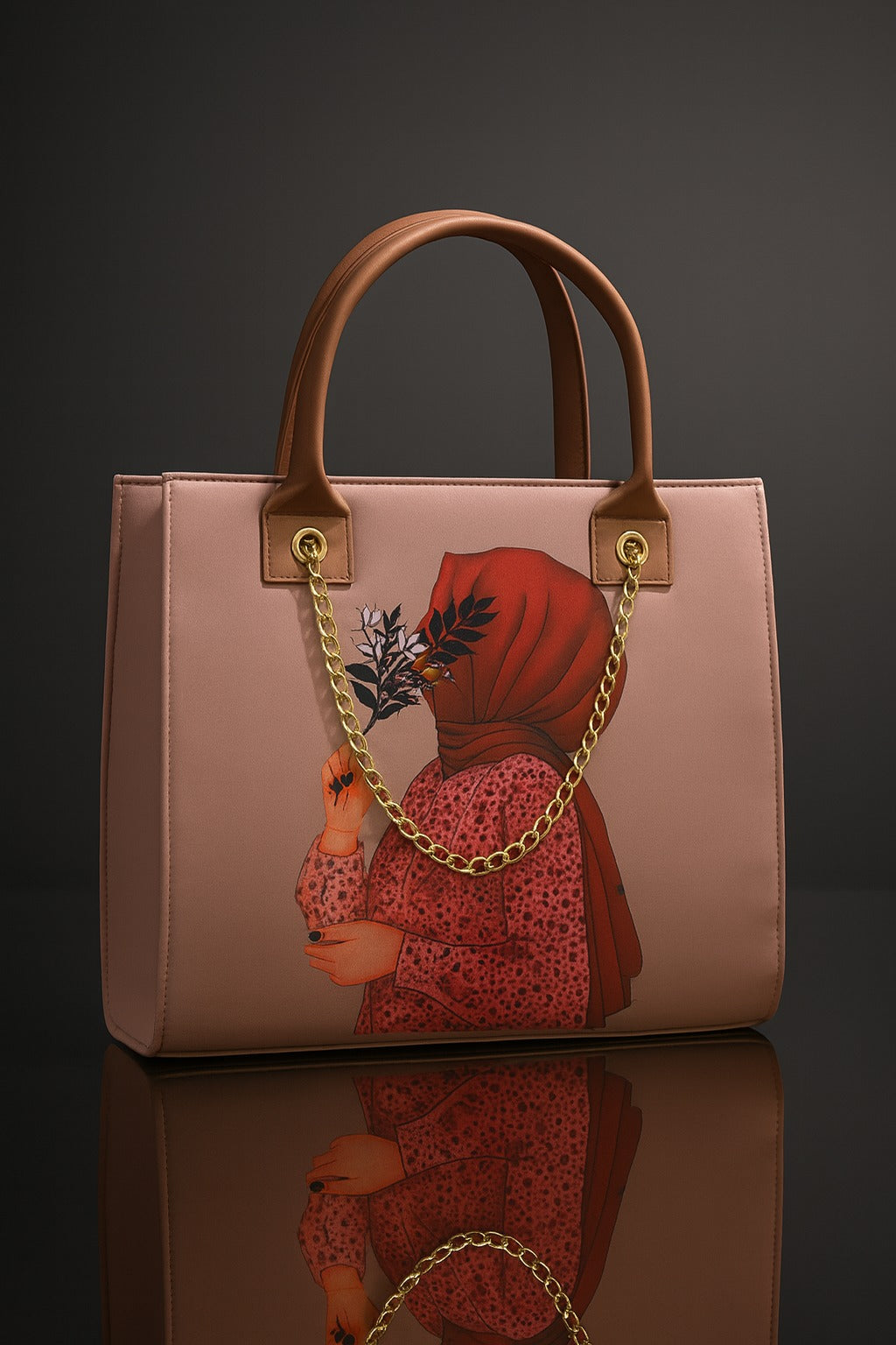 Pink handbag with a decorative chain and design on a reflective surface.