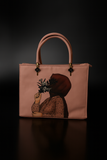 Pink handbag with a printed design of a person holding a plant on a black background