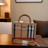 Plaid patterned handbag with a strap on a wooden surface