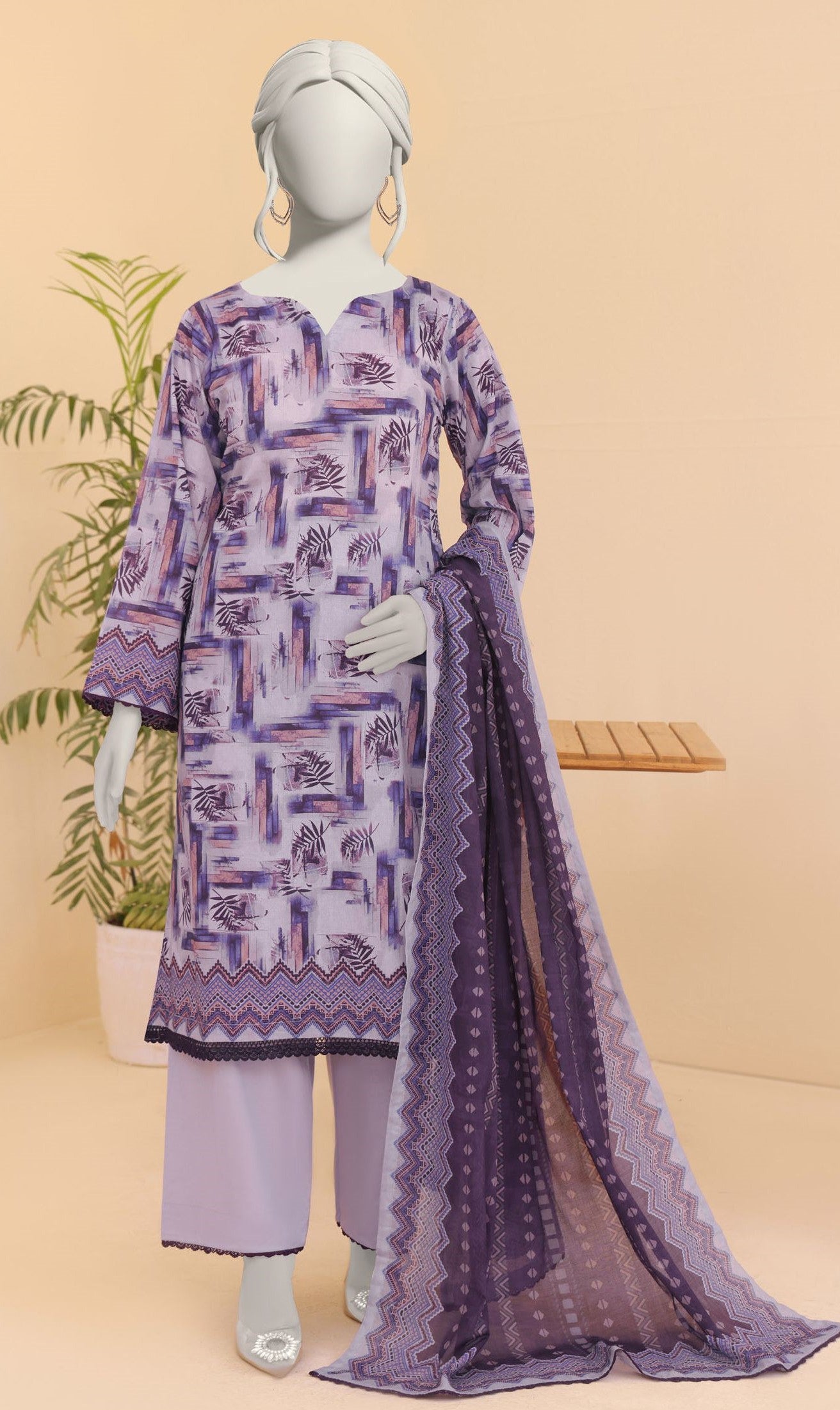 Purple patterned outfit with a dupatta on a mannequin against a beige background