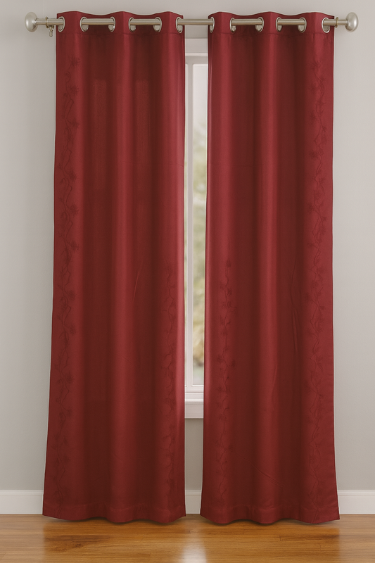 Red curtains with grommets on a white wall