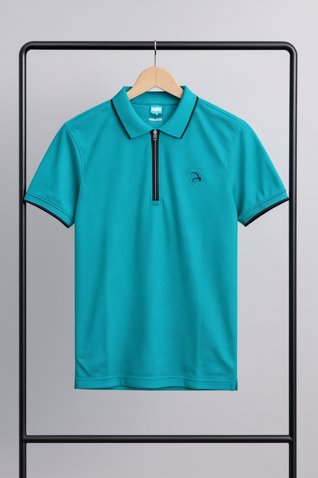 Teal polo shirt on a hanger against a gray background