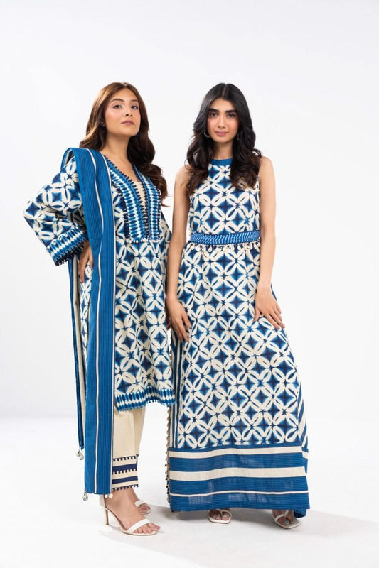 Two women wearing blue and white patterned outfits on a white background