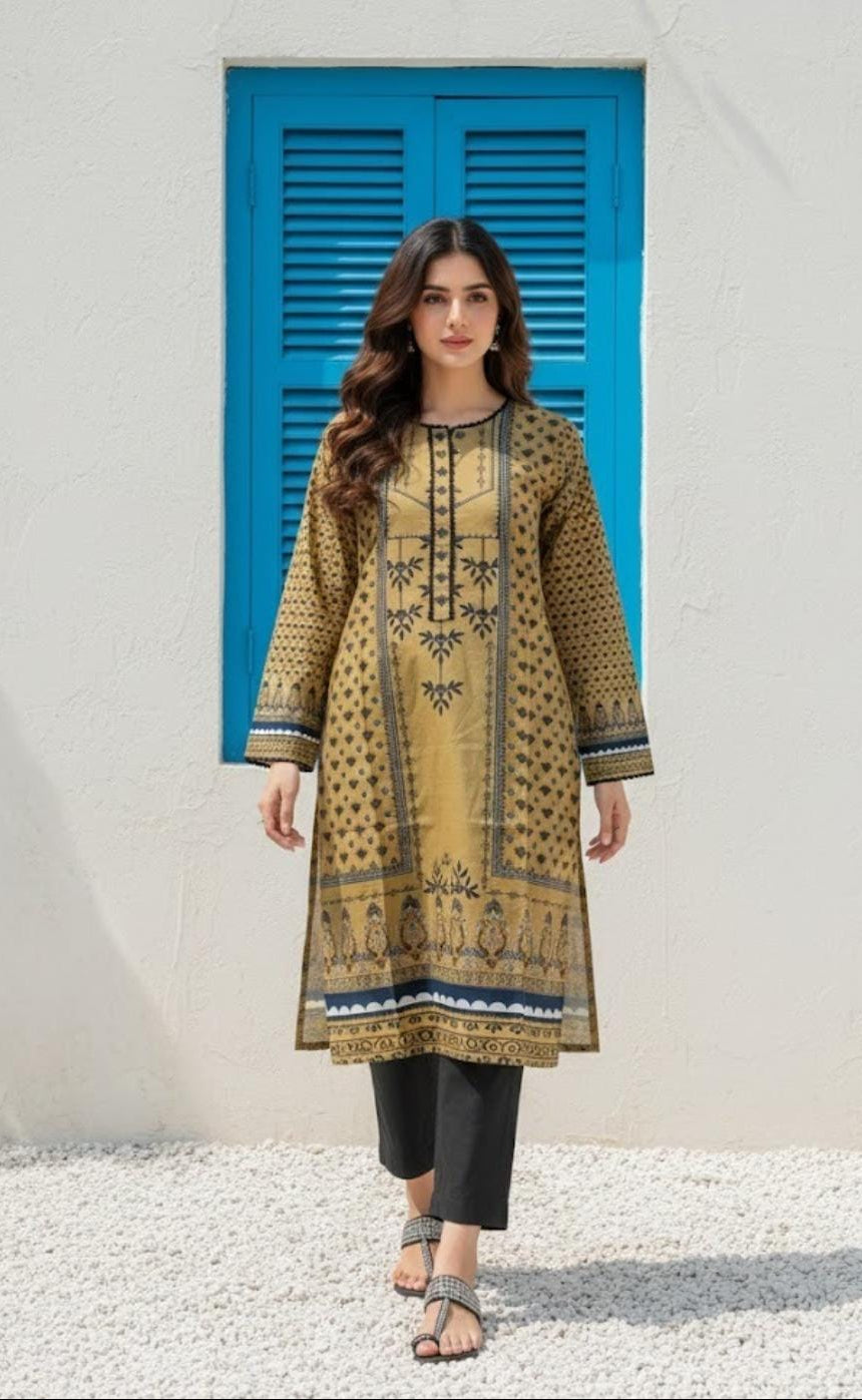 Woman wearing a patterned yellow and black outfit with black pants in front of a blue shutter.