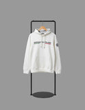 White hoodie with brand logo on a black stand against a gray background